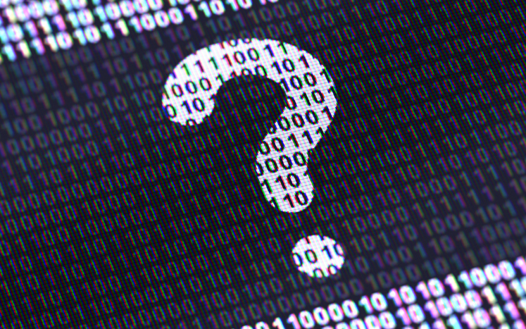 A question mark made of ones and zeros appears on a screen in black and white.