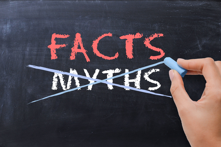 The words facts and myths are on a chalkboard and the word myths is being crossed out.