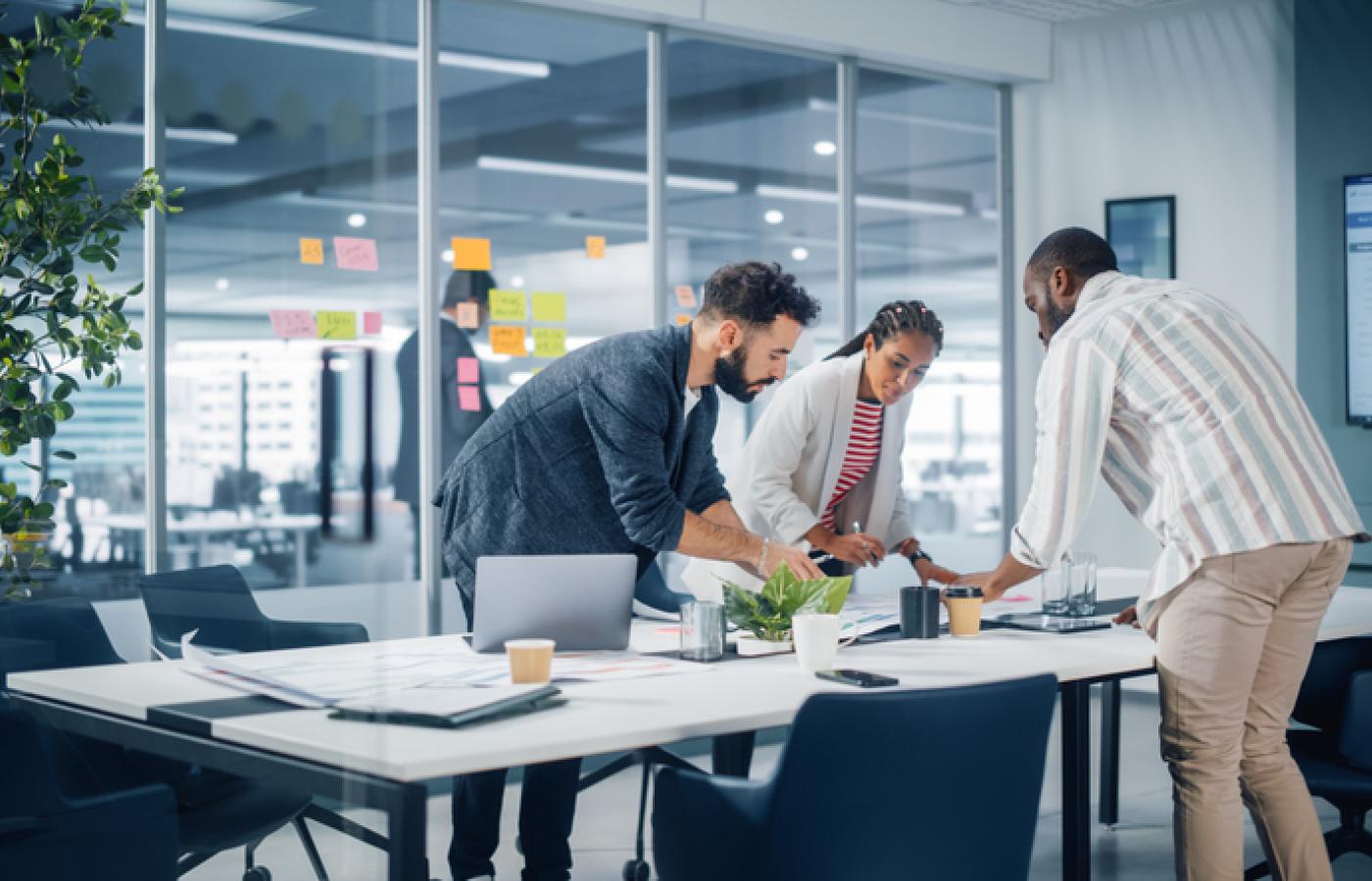 A team look over their plans at a table.