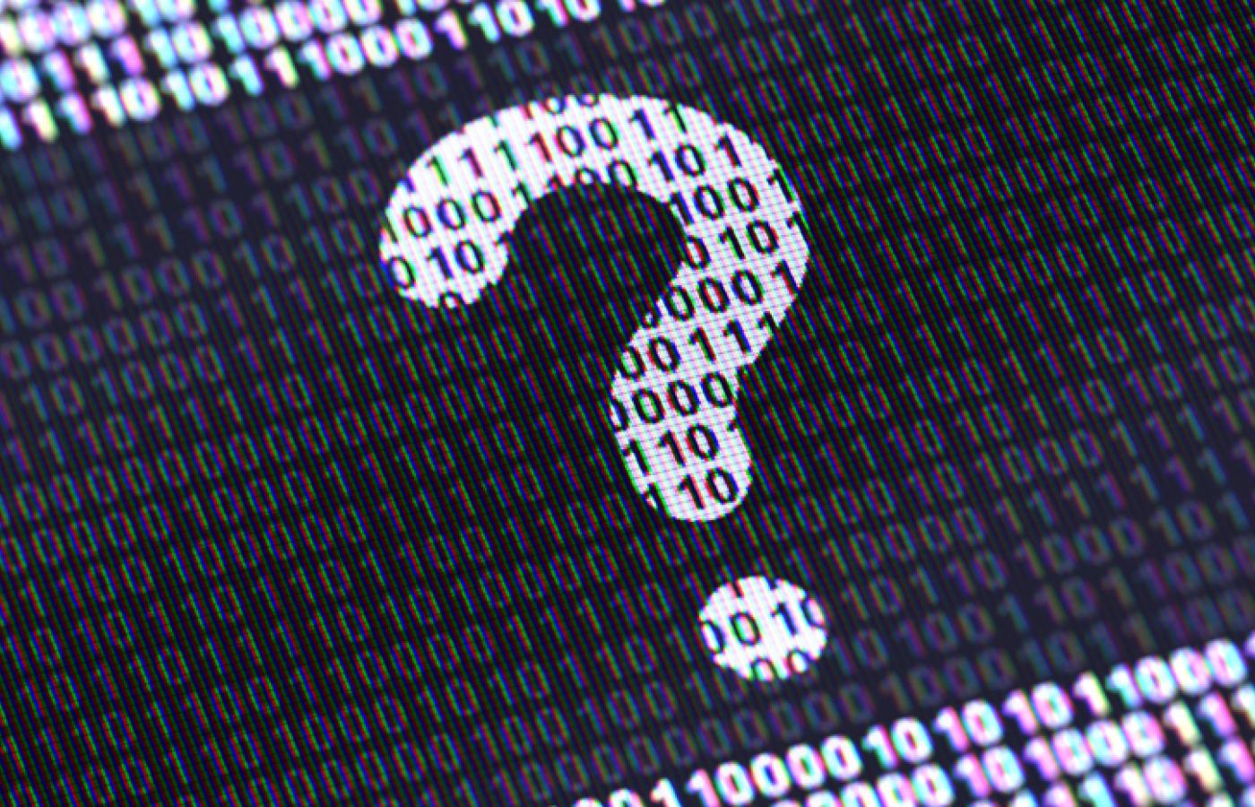 A question mark made of ones and zeros appears on a screen in black and white.