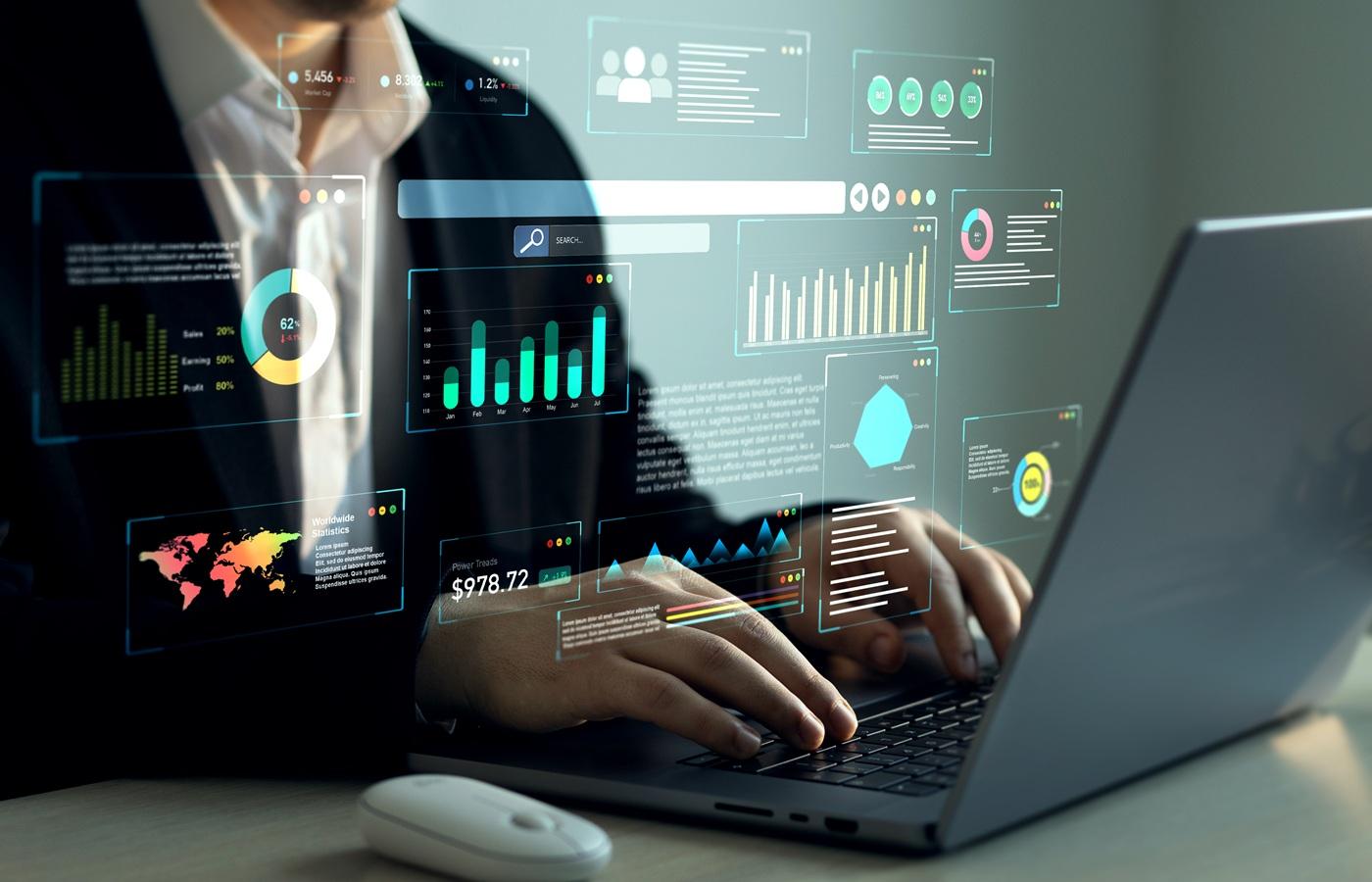 Person working on a laptop with data charts and reports overlayed on the screen, representing operational efficiency and business performance analysis.