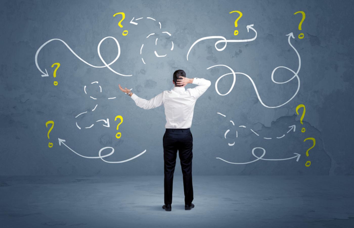 A man stands confused about design decisions.