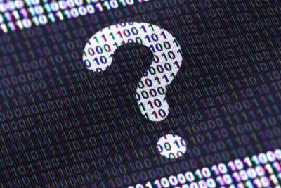 A question mark made of ones and zeros appears on a screen in black and white.