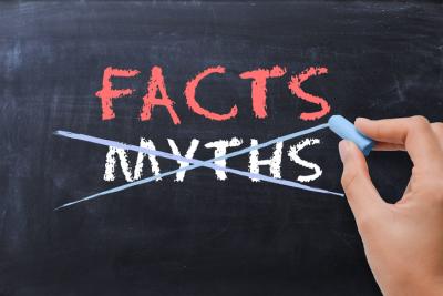 The words facts and myths are on a chalkboard and the word myths is being crossed out.