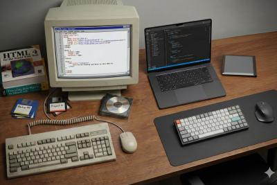 A computer desk showing technology 30 years apart. AI generated.